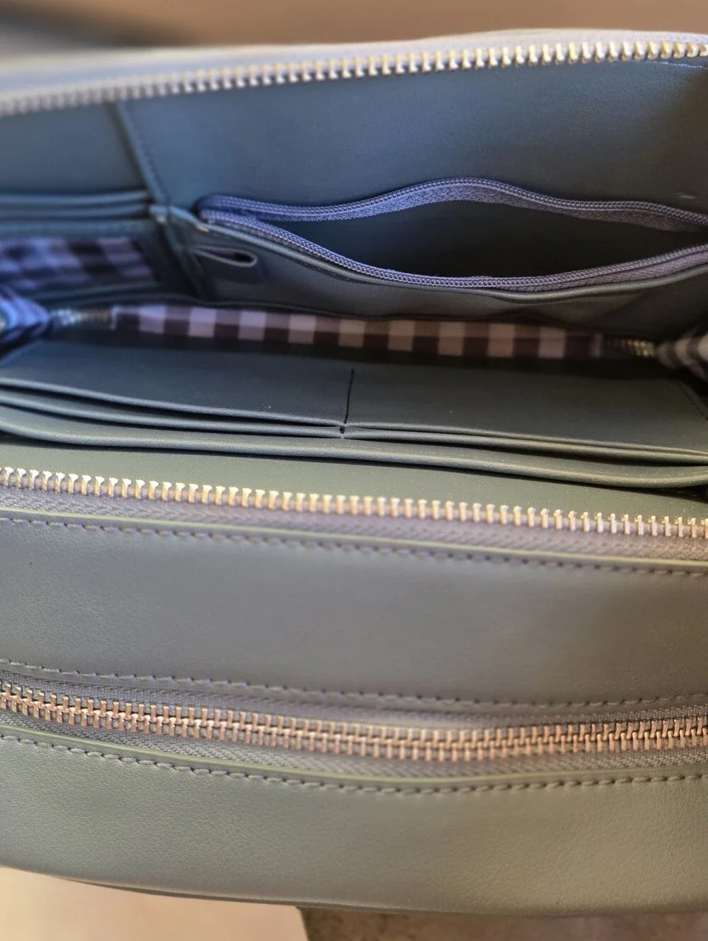 This is a TWELVElittle x The Sensible Mama Clutch in a muted blue vegan leather.